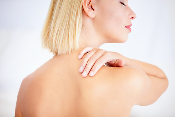 Image showing Woman, skincare and touch shoulder in studio with back, eyes closed and beauty by white background. Girl, model and blonde with smooth skin, cosmetic change and transformation with glow for wellness