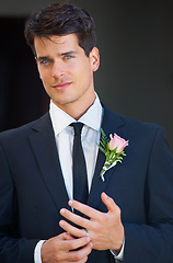 Image showing Groom man, portrait and wedding in suit, rose or flower for celebration, event or party with ring. Person, hands and face with choice, marriage and commitment to relationship with floral decoration