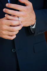 Image showing Groom, hand closeup and ring for marriage, ceremony or celebration in suit, fingers and event. Person, palm and metal jewelry for wedding, party or commitment to relationship, engagement or proposal