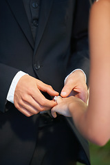 Image showing Couple, hands and wedding ring for marriage, commitment or promise in love, care or trust and support at ceremony. Closeup of married man putting jewelry on bride for loyalty, proposal or engagement