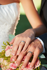 Image showing Couple, wedding ring and hands in marriage with rose bouquet at celebration and trust event. Flower, loyalty and care with romance and groom jewelry with love and commitment with woman and man