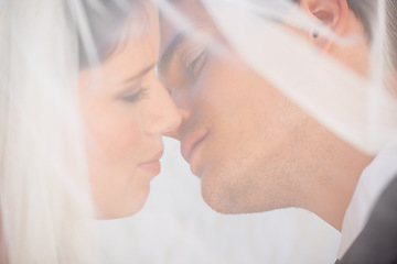 Image showing Veil, man and woman kiss at wedding with romance, love or commitment at luxury reception. Fabric, face of bride and groom in embrace at marriage celebration with happiness, loyalty or future together