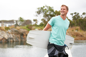 Image showing Sports, happy and man by lake with wakeboard for surfing, exercise and recreation hobby outdoors. Fitness, extreme sport and excited person with board for water skiing for freedom, adventure and fun