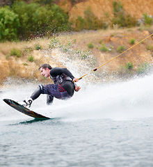 Image showing Trick, wakeboarding and adventure, man on lake with outdoor fun, fitness and wave splash. Balance, water sports and person on river with freedom, speed and energy for surfing challenge, ski and sun.