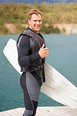 Image showing Lake, thumbs up and portrait of man with wakeboard for surfing, exercise and hobby outdoors. Fitness, extreme sports and person with emoji and board for water skiing for freedom, adventure and fun