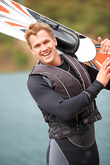 Image showing Sports, portrait and man by water with wakeboard for surfing, exercise and recreation hobby by lake. Fitness, extreme sport and excited person with skiing board for freedom, adventure and outdoor fun