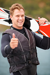 Image showing Sports, thumbs up and portrait of man with wakeboard for surfing, exercise and recreation hobby by lake. Fitness, emoji hand sign and person with board for water skiing for freedom, adventure and fun