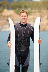 Image showing Lake, ski and portrait of man with wakeboard for surfing, exercise and recreation hobby outdoors. Fitness, extreme sports and happy person with board for water skiing for freedom, adventure and fun