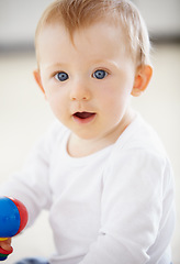 Image showing Happy, playing and baby with toys on floor in home for child development, health and growth. Family, youth and closeup of young infant in living room for educational, motor skills and wellness