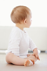 Image showing Home, playing and curious baby on floor to relax, resting and calm in nursery learning to crawl in morning. Family, youth and infant kid in bedroom for child development, growth and wellness