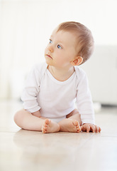 Image showing Home, playing and baby on floor in living room to relax, resting and calm in nursery learning to crawl in morning. Family, youth and infant newborn for child development, growth and wellness in house