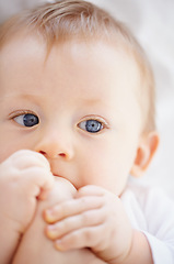 Image showing Home, bed and face of baby with feet relax, resting and calm in nursery wake up in morning. Family, youth and closeup of newborn in bedroom playing with toes for child development, fun and wellness