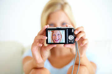 Image showing Portrait, smile and woman with a digital camera, happiness and memory with break, excited or cheerful. Face, person or girl with equipment, photography or joyful with peace, screen or home with frame