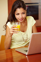 Image showing Morning, laptop and woman doing remote work with juice for breakfast in a home. Table, online and working freelancer with social media scroll and computer with a smile from technology in a house