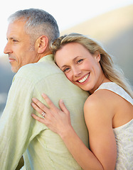 Image showing Happy woman, portrait and hug man in marriage, love or embrace for honeymoon, romance or care together. Mature couple or female person hugging groom with smile outdoor in support, trust or commitment