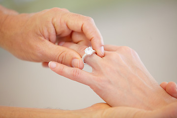 Image showing People, hands and wedding ring for marriage, love or commitment together in promise at ceremony. Closeup of married groom putting diamond jewelry or accessory on bride for engagement, romance or care