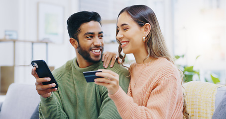 Image showing Phone, love and couple with credit card on a sofa for loan, payment or banking in their home. Investment, growth and people with smartphone, app and online shopping, sale or ecommerce sign up choice