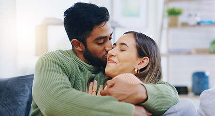 Image showing Kiss, hug and couple on a sofa with love, relax and security at home bonding, hanging out or chilling. Happy, support and people in a living room with trust, commitment and gratitude, care or romance