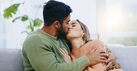 Image showing Love, hug and couple kissing on a sofa with romance, bond and intimacy at home together. Passion, desire and people embrace in a living room with romance, moment or soulmate connection in a house