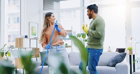 Image showing Couple, home and cleaning with singing, broom and comic performance in living room, hygiene and teamwork. Man, woman and happy with funny dancing, concert or game with help for dirt, dust or bacteria