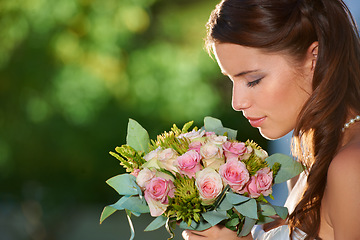 Image showing Woman, smell and wedding rose bouquet with love, commitment and trust ceremony for marriage. Engagement, celebration and flowers for event in a park with a red floral plant and bride dress outdoor