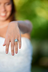 Image showing Bride, woman and hand with wedding ring outdoor for marriage, commitment and celebration with diamond. Love, unity and person in nature with jewelry for ceremony, faith and support on park in summer