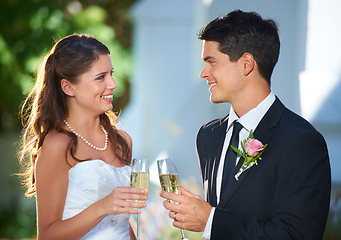 Image showing Happy couple, wedding and champagne in celebration for marriage, love or commitment at outdoor ceremony. Married man and woman smile with glass of alcohol for toast, date or cheers on honeymoon