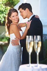 Image showing Happy couple, wedding and hug with champagne glasses in celebration for love, commitment or outdoor marriage. Man hugging woman smile in embrace, affection or support with alcohol at bridal ceremony