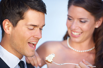 Image showing Happy, wedding and couple eating cake together for celebration of love together at party. Smile, cute and young bride feed husband sweet dessert at romantic marriage ceremony or event with commitment