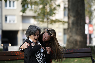 Image showing Elderly old cute woman with Alzheimer's very happy and smiling when eldest daughter hugs and takes care of her