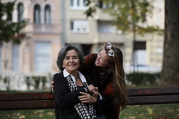 Image showing Elderly old cute woman with Alzheimer's very happy and smiling when eldest daughter hugs and takes care of her