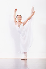 Image showing Portrait, stretching and girl in ballet studio with pose, balance and modern dance class. Performance, talent and young ballerina dancer with pride, confidence and creative child at learning academy.