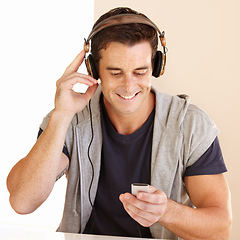 Image showing Man, music player and headphones in home for listening to audio, digital radio and podcast. Happy guy streaming portable playlist of songs, hearing sound and multimedia subscription for entertainment