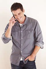 Image showing Man, smile and phone call in studio for communication, social networking and hello to mobile contact on white background. Happy guy talking on smartphone for chat, conversation and digital feedback