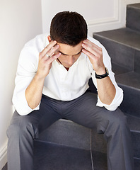 Image showing Businessman, sitting on stairs and stress with headache, thinking and overworked with frustration, problem or tired. Alone, male person or burnout with job, exhausted or migraine for financial crisis