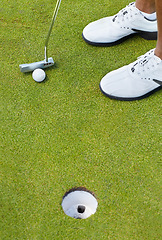 Image showing Sports, golf hole and shoes of person on course playing game, practice and training for competition. Professional golfer, grass and closeup of tee, ball and golfing club for winning stroke or score