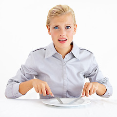 Image showing Confused, hungry and woman with empty plate in studio with bored, upset or shock face. Surprise, frustrated and portrait of female person from Australia with dish and cutlery by white background.