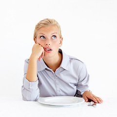 Image showing Bored, hungry and woman with a plate in a studio with upset, frustrated and grumpy face. Angry, moody and young female person from Australia with dish and cutlery isolated by white background.