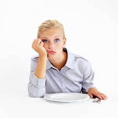 Image showing Hungry, portrait and woman with a plate in a studio with upset, frustrated and grumpy face. Bored, moody and young female person from Australia with dish and cutlery isolated by white background.