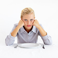 Image showing Bored, portrait and woman with a plate in a studio with upset, frustrated and grumpy face. Angry, hungry and young female person from Australia with dish and cutlery isolated by white background.