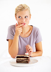 Image showing Sneaky, cake and young woman in a studio cheating on healthy, wellness or weight loss diet. Yummy, sweet and female person from Australia eating a chocolate dessert isolated by white background.