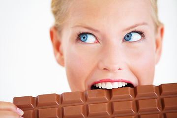 Image showing Studio face, woman thinking or eating chocolate bar, delicious snack or idea for candy food, dessert or sugar product. Diet plan, looking or girl bite, taste or enjoy cacao sweets on white background