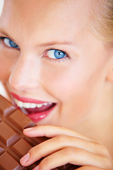 Image showing Studio portrait, woman and eating chocolate slab bar, taste snack or unhealthy junk food, dessert or sugar candy. Wellness craving, closeup beauty face or person bite tasty sweets on white background