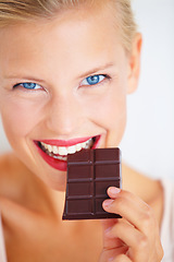 Image showing Portrait, woman happiness and eating dark chocolate bar, tasty cocoa snack or unhealthy junk food, dessert or sweets. Diet craving, antioxidants benefits and model face, smile or happy for cacao slab