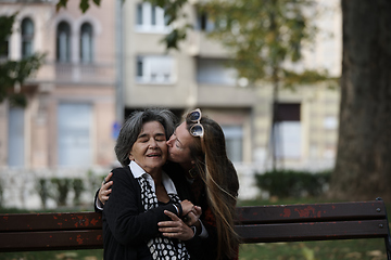 Image showing Elderly old cute woman with Alzheimer's very happy and smiling when eldest daughter hugs and takes care of her