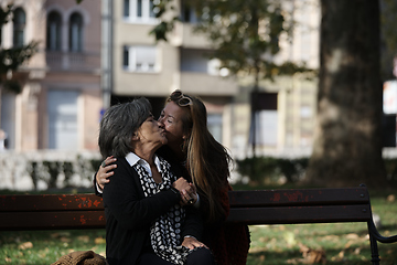 Image showing Elderly old cute woman with Alzheimer's very happy and smiling when eldest daughter hugs and takes care of her