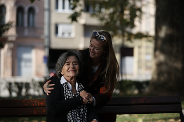 Image showing Elderly old cute woman with Alzheimer's very happy and smiling when eldest daughter hugs and takes care of her