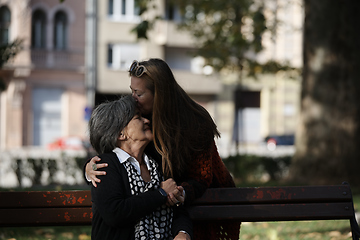 Image showing Elderly old cute woman with Alzheimer's very happy and smiling when eldest daughter hugs and takes care of her