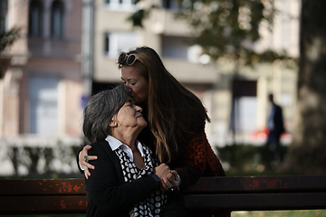 Image showing Elderly old cute woman with Alzheimer's very happy and smiling when eldest daughter hugs and takes care of her