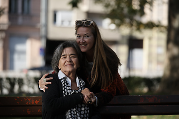 Image showing Elderly old cute woman with Alzheimer's very happy and smiling when eldest daughter hugs and takes care of her